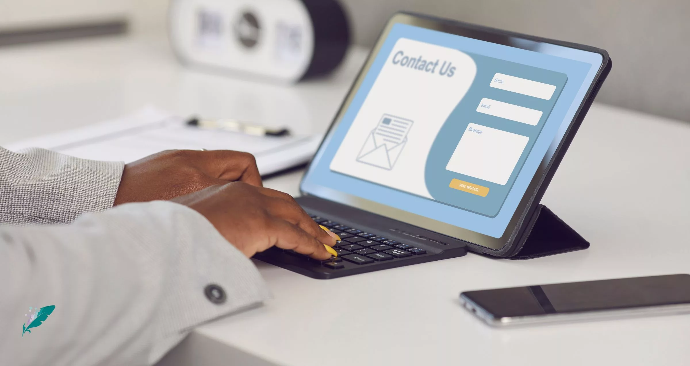 a person's hands seen on a keyboard completing a contact us form
