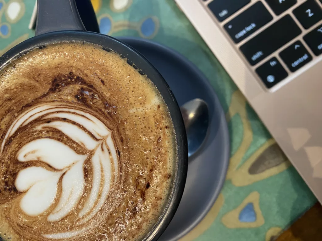 Coffee and laptop at a cafe